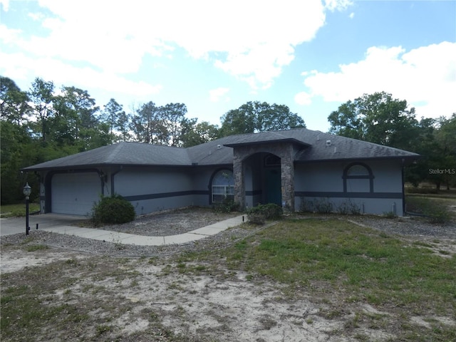 single story home featuring driveway, stucco siding, and an attached garage