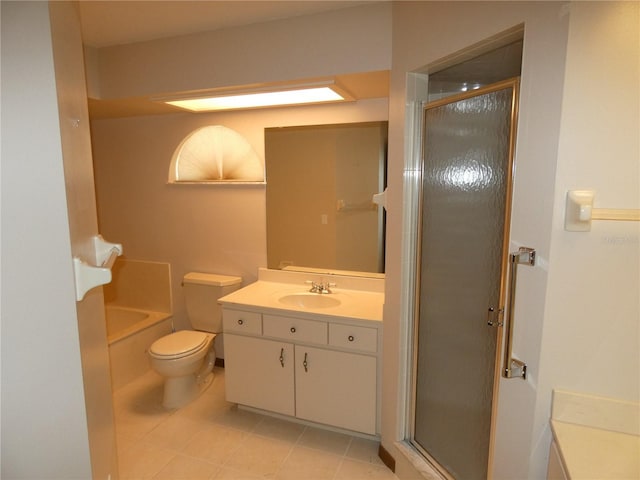 bathroom featuring toilet, a shower stall, vanity, tile patterned floors, and a washtub