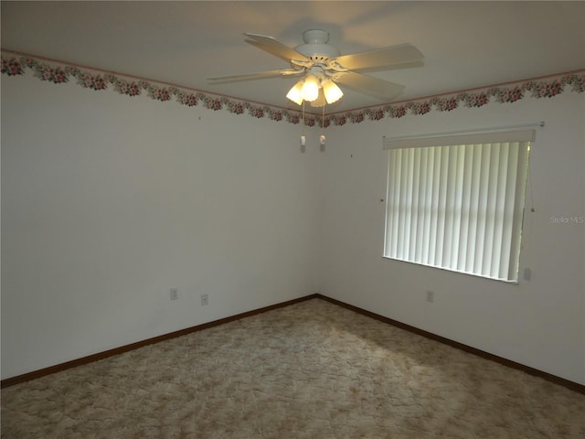 spare room featuring baseboards and ceiling fan