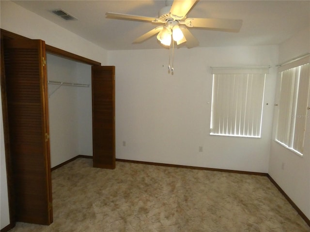 unfurnished bedroom with visible vents, a ceiling fan, a closet, and carpet