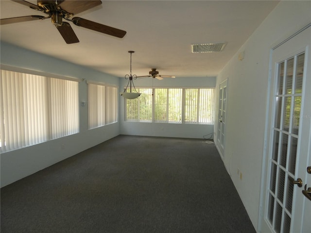 carpeted empty room with visible vents and ceiling fan