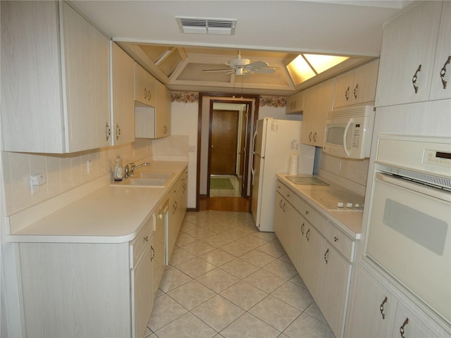 20364 SW 86th Loop, Dunnellon, FL 34431 - kitchen with white appliances, a sink, light tile patterned floors, light countertops, and a ceiling fan