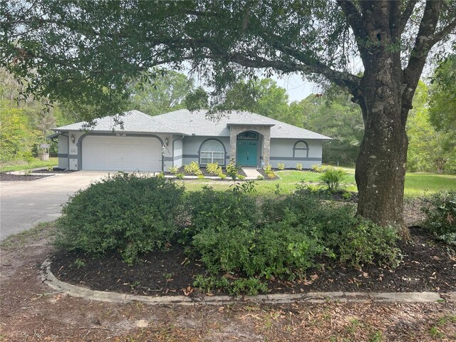 20364 SW 86th Loop, Dunnellon, FL 34431 - ranch-style house featuring stucco siding, a garage, and driveway