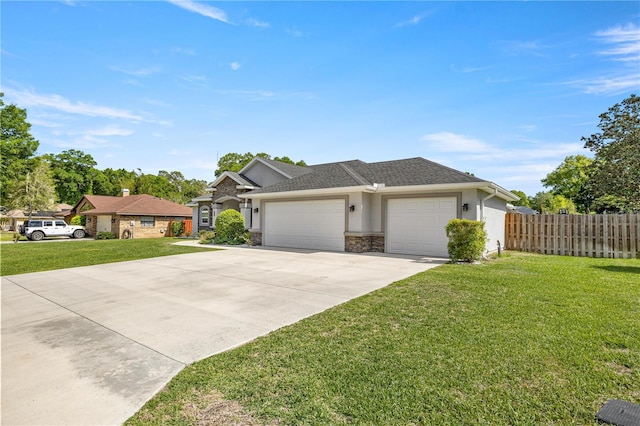 ranch-style house with fence, stucco siding, driveway, a front yard, and a garage