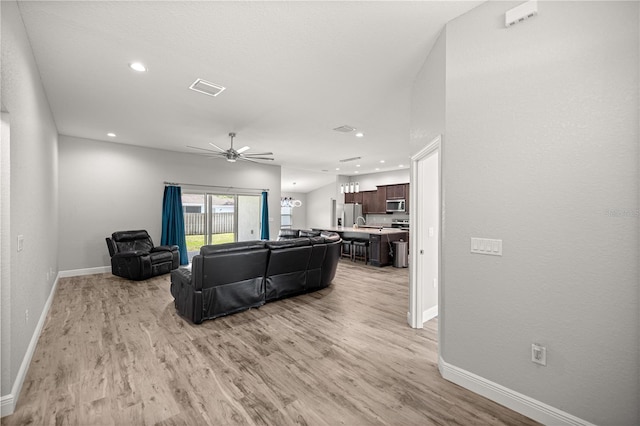 living area with recessed lighting, visible vents, a ceiling fan, baseboards, and light wood-style flooring