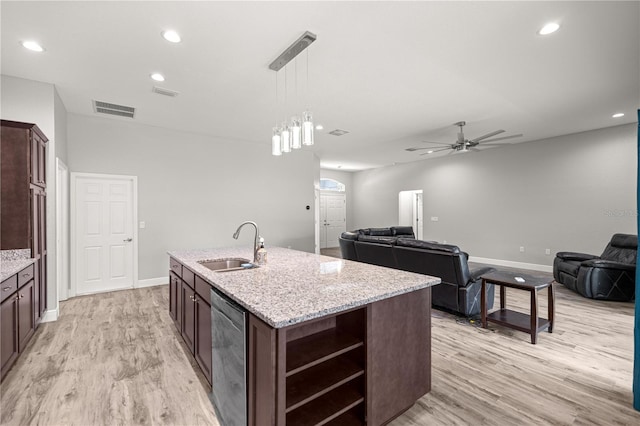kitchen with stainless steel dishwasher, a ceiling fan, a sink, light wood finished floors, and visible vents