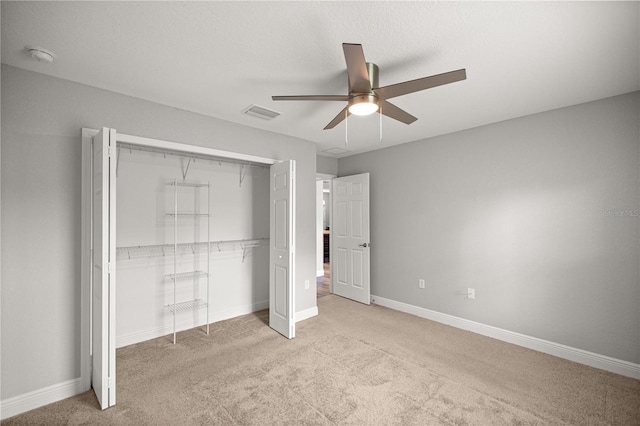 unfurnished bedroom with baseboards, a closet, light colored carpet, and visible vents