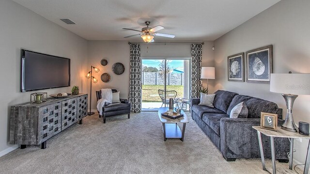 carpeted living area featuring a ceiling fan and visible vents