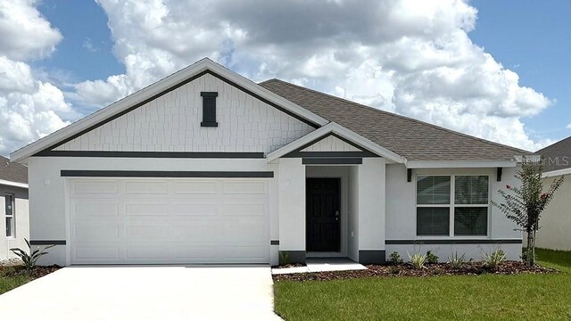 4730 SW 88th Ln, Ocala, FL 34476 - view of front of property featuring driveway, an attached garage, roof with shingles, a front lawn, and stucco siding