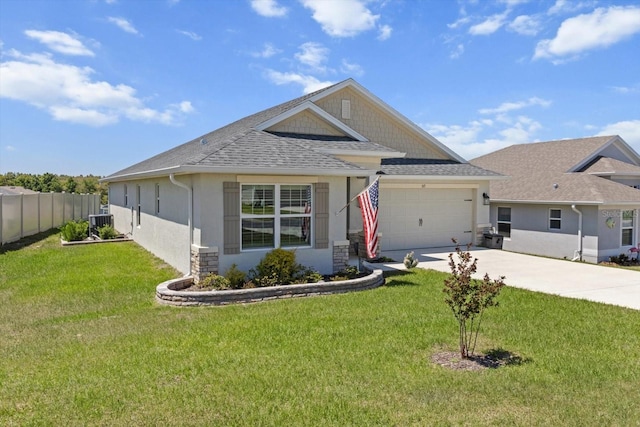 view of front of property featuring roof with shingles, concrete driveway, fence, an attached garage, and a front yard