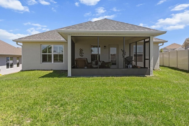 back of property with stucco siding, roof with shingles, and a sunroom