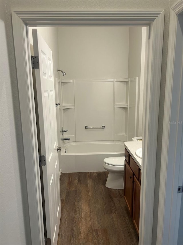 full bathroom with toilet, vanity, wood finished floors, and tub / shower combination