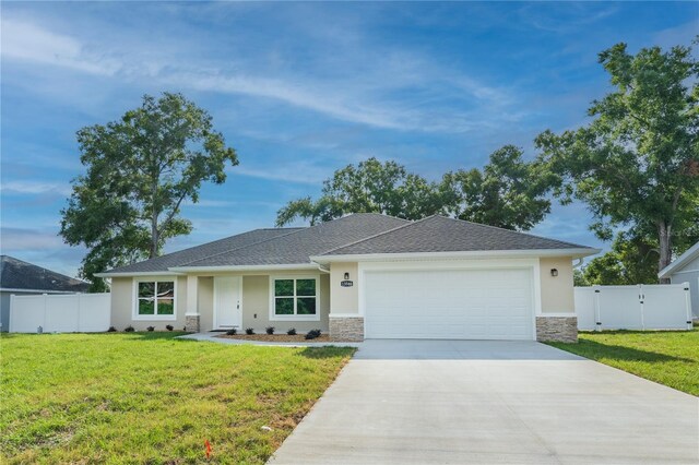 single story home with a front lawn, stone siding, a garage, stucco siding, and driveway