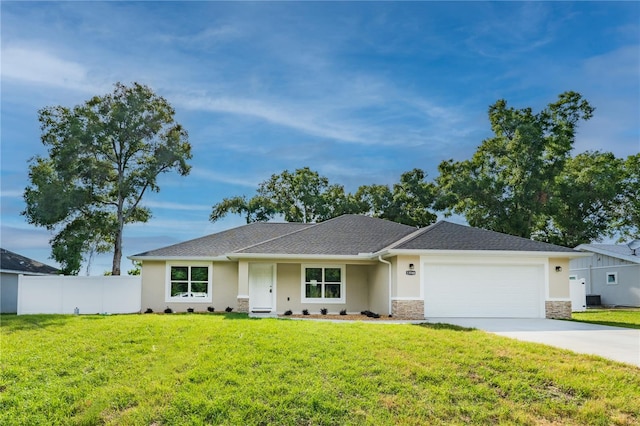 single story home with fence, an attached garage, a front lawn, stucco siding, and concrete driveway