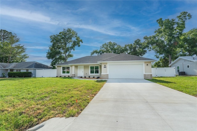 single story home with a garage, fence, concrete driveway, and a front yard