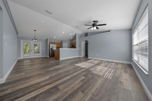 2312 SW 140th Ct, Ocala, FL 34481 - unfurnished living room with vaulted ceiling, a ceiling fan, dark wood-type flooring, arched walkways, and french doors
