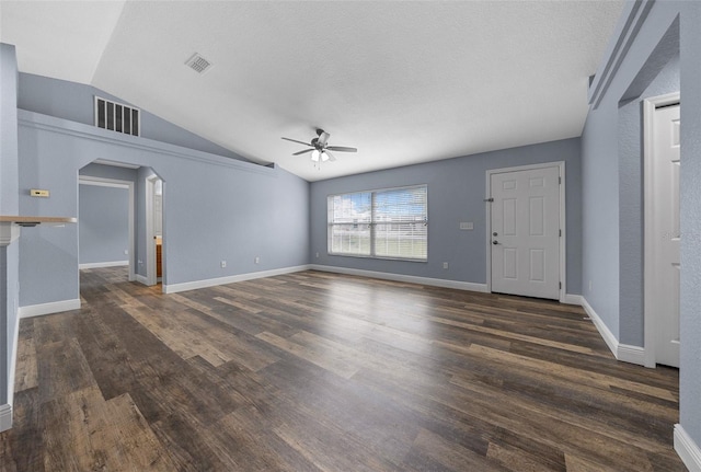 2312 SW 140th Ct, Ocala, FL 34481 - unfurnished living room with a ceiling fan, lofted ceiling, arched walkways, dark wood-style flooring, and baseboards