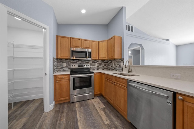 2312 SW 140th Ct, Ocala, FL 34481 - kitchen featuring stainless steel appliances, a sink, dark wood-style floors, backsplash, and light countertops
