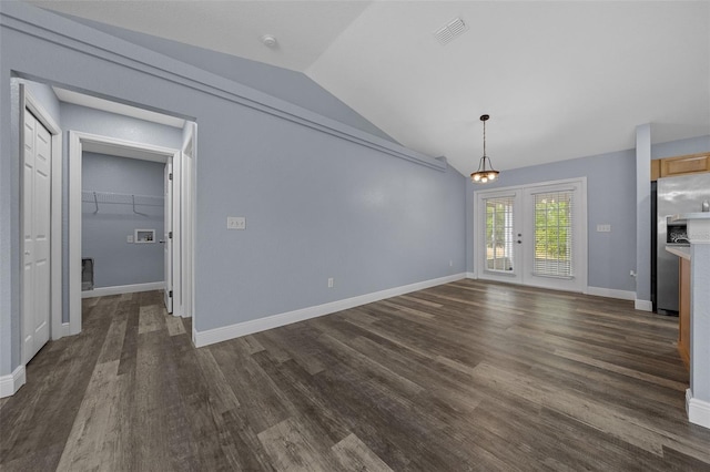 2312 SW 140th Ct, Ocala, FL 34481 - unfurnished living room featuring lofted ceiling, french doors, dark wood-type flooring, and baseboards