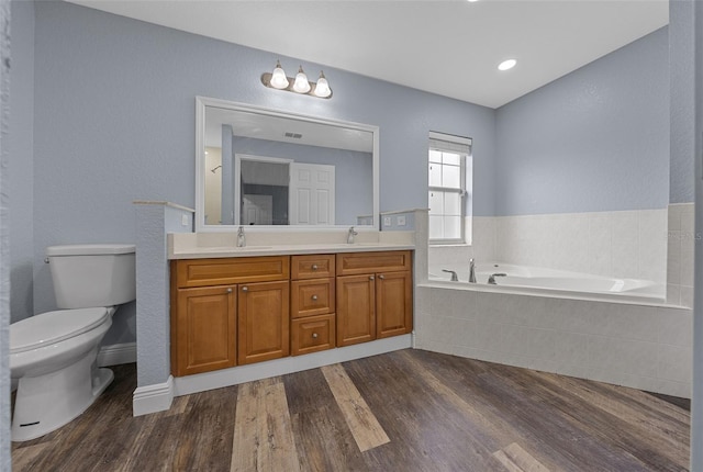 2312 SW 140th Ct, Ocala, FL 34481 - bathroom featuring toilet, a garden tub, double vanity, and wood finished floors