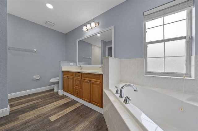 2312 SW 140th Ct, Ocala, FL 34481 - full bathroom featuring vanity, a bath, toilet, and plenty of natural light