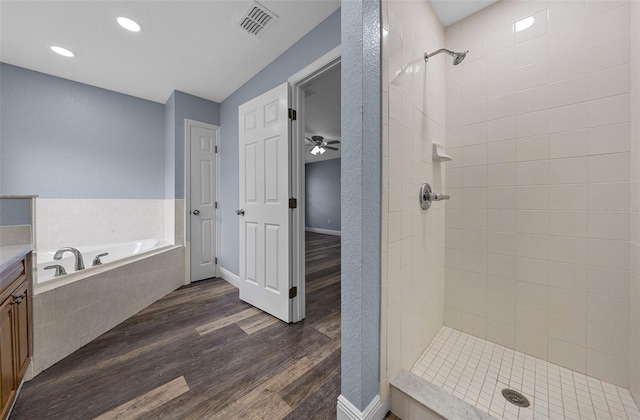 2312 SW 140th Ct, Ocala, FL 34481 - bathroom featuring a tile shower, wood finished floors, a garden tub, vanity, and recessed lighting