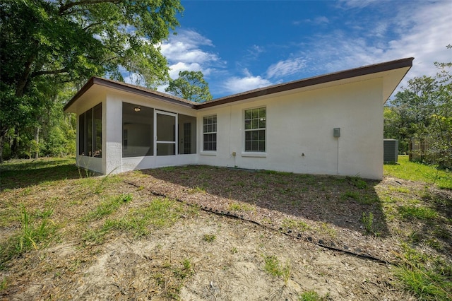2312 SW 140th Ct, Ocala, FL 34481 - back of house featuring a sunroom, stucco siding, and cooling unit