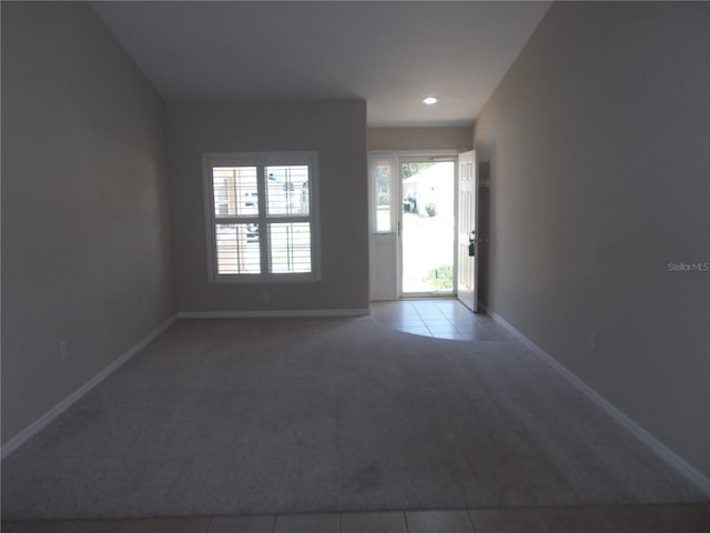 11653 SW 72nd Cir, Ocala, FL 34476 - spare room featuring carpet floors, baseboards, tile patterned flooring, and recessed lighting
