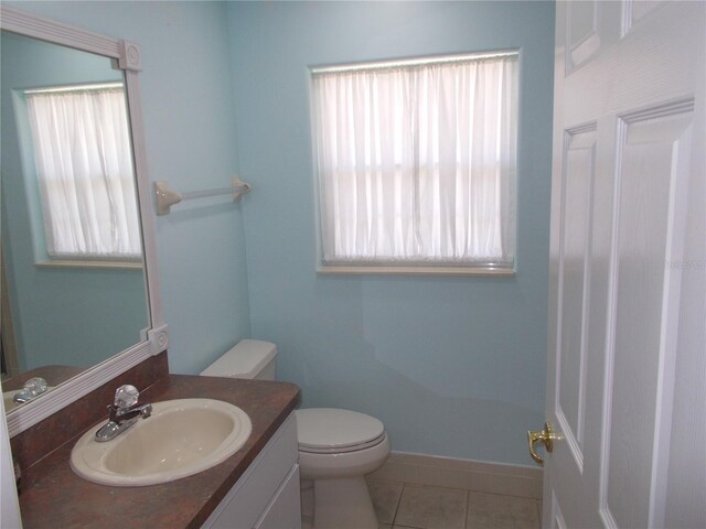 11653 SW 72nd Cir, Ocala, FL 34476 - bathroom featuring toilet, vanity, tile patterned floors, and baseboards