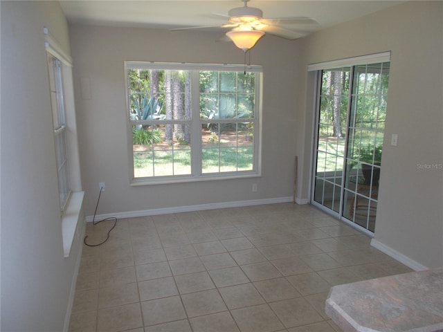 11653 SW 72nd Cir, Ocala, FL 34476 - spare room with ceiling fan, light tile patterned flooring, and baseboards