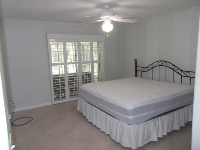 11653 SW 72nd Cir, Ocala, FL 34476 - bedroom with baseboards, light tile patterned flooring, and a ceiling fan