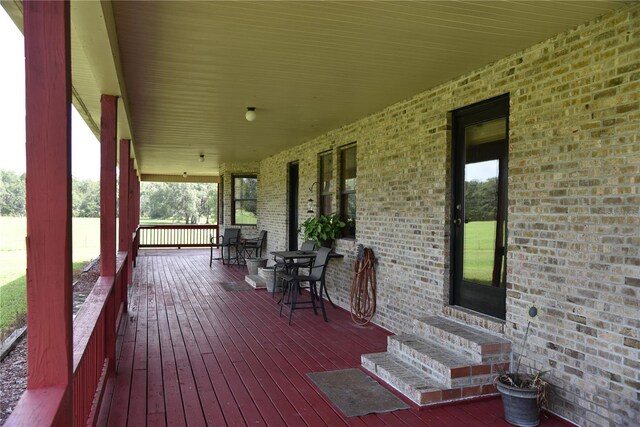 deck featuring a porch and entry steps