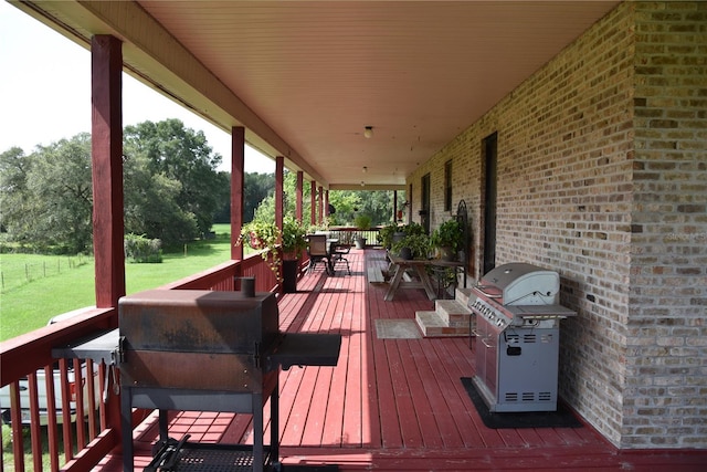 deck featuring grilling area and a yard