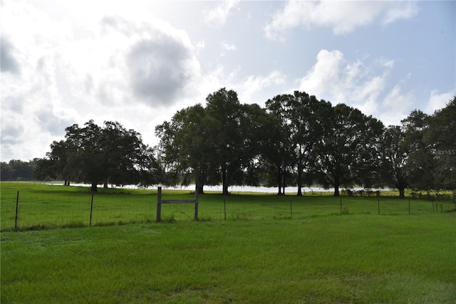 view of yard featuring a rural view and fence