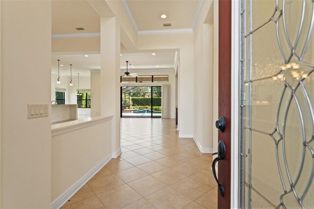 foyer entrance with light tile patterned floors, recessed lighting, ornamental molding, and baseboards