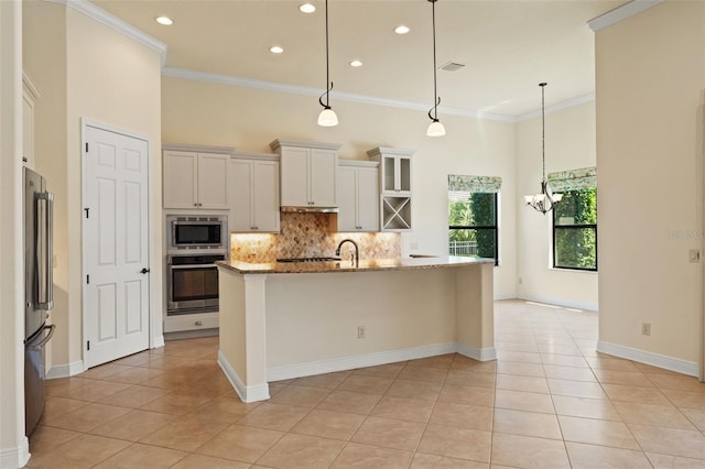 kitchen with light stone countertops, decorative backsplash, stainless steel appliances, visible vents, and light tile patterned flooring
