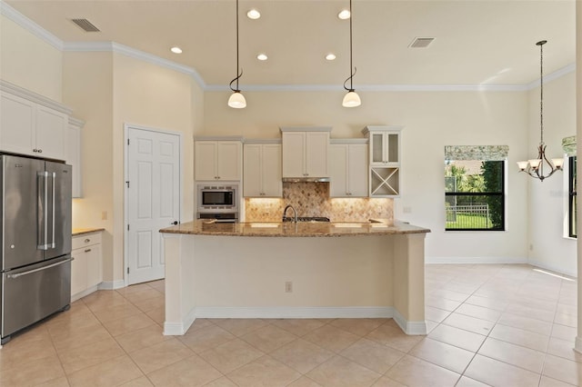 kitchen with light tile patterned floors, crown molding, visible vents, and stainless steel appliances