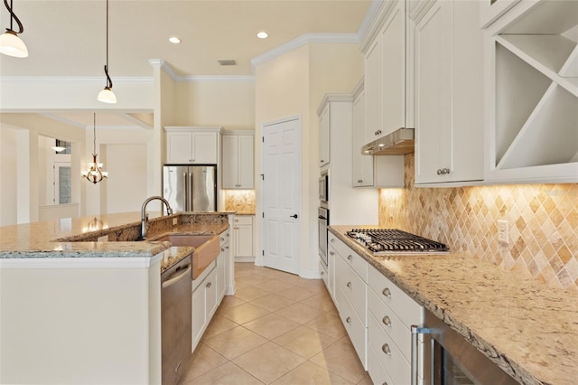 kitchen with a sink, stainless steel appliances, decorative backsplash, light tile patterned floors, and crown molding