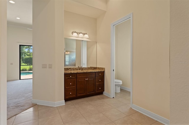 bathroom featuring recessed lighting, tile patterned floors, toilet, vanity, and baseboards