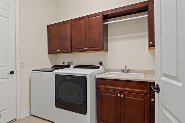 laundry area with washer and clothes dryer, cabinet space, and a sink