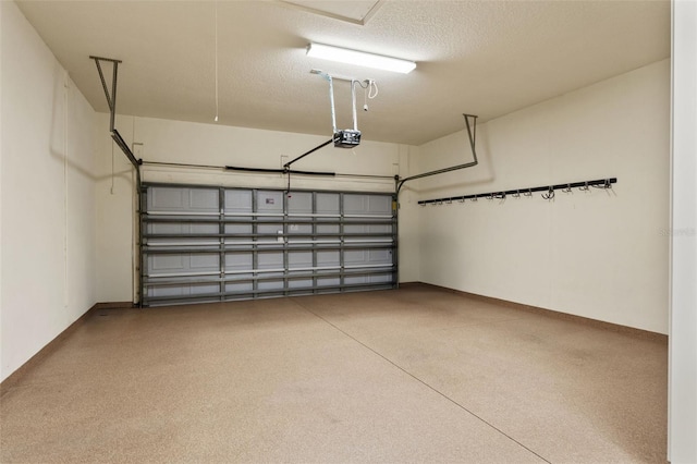 garage featuring a garage door opener and baseboards