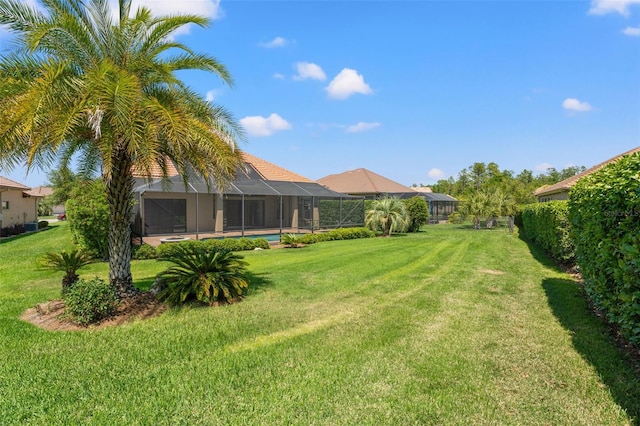view of yard with an outdoor pool and a lanai