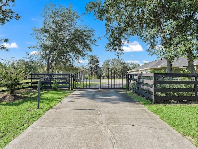 4658 W Hacienda Dr, Beverly Hills, FL 34465 - view of gate featuring fence and a yard