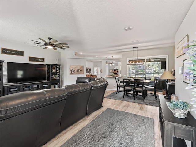 4658 W Hacienda Dr, Beverly Hills, FL 34465 - living area with light wood finished floors, visible vents, and a ceiling fan