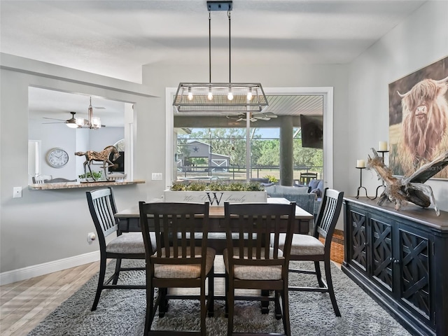 4658 W Hacienda Dr, Beverly Hills, FL 34465 - dining space with baseboards, a notable chandelier, and wood finished floors