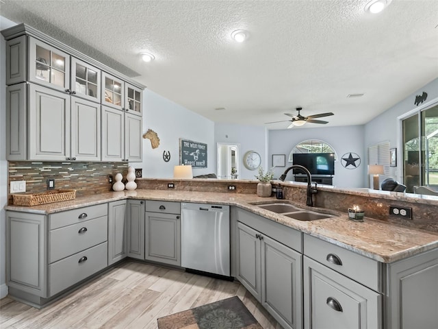 4658 W Hacienda Dr, Beverly Hills, FL 34465 - kitchen featuring a sink, a textured ceiling, light wood-type flooring, gray cabinets, and dishwasher