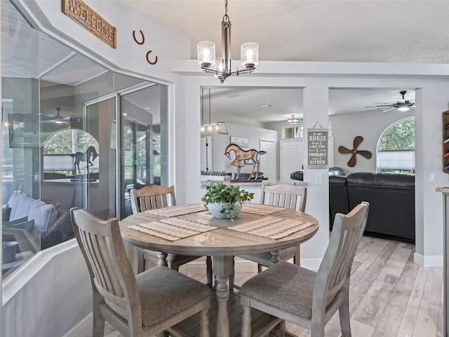 4658 W Hacienda Dr, Beverly Hills, FL 34465 - dining space with light wood-style flooring, baseboards, and ceiling fan with notable chandelier