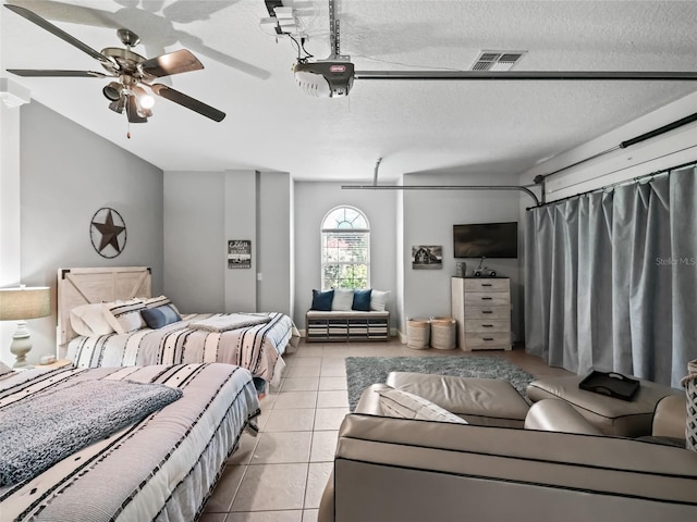 4658 W Hacienda Dr, Beverly Hills, FL 34465 - bedroom featuring a garage, tile patterned floors, visible vents, and a textured ceiling