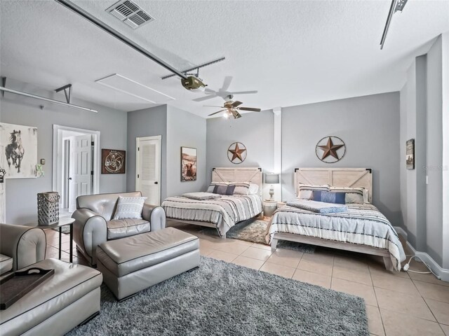 4658 W Hacienda Dr, Beverly Hills, FL 34465 - tiled bedroom featuring attic access, ceiling fan, a textured ceiling, and visible vents