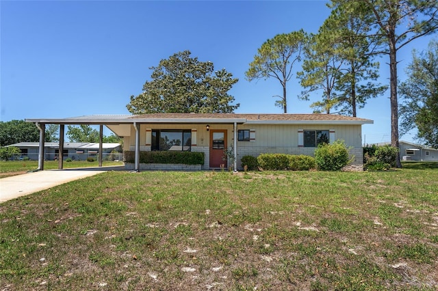 single story home with concrete driveway, brick siding, a carport, and a front yard